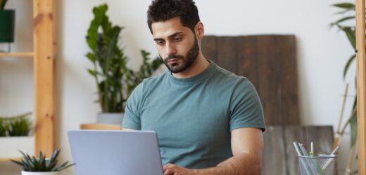 Bearded Man using laptop at Home Office