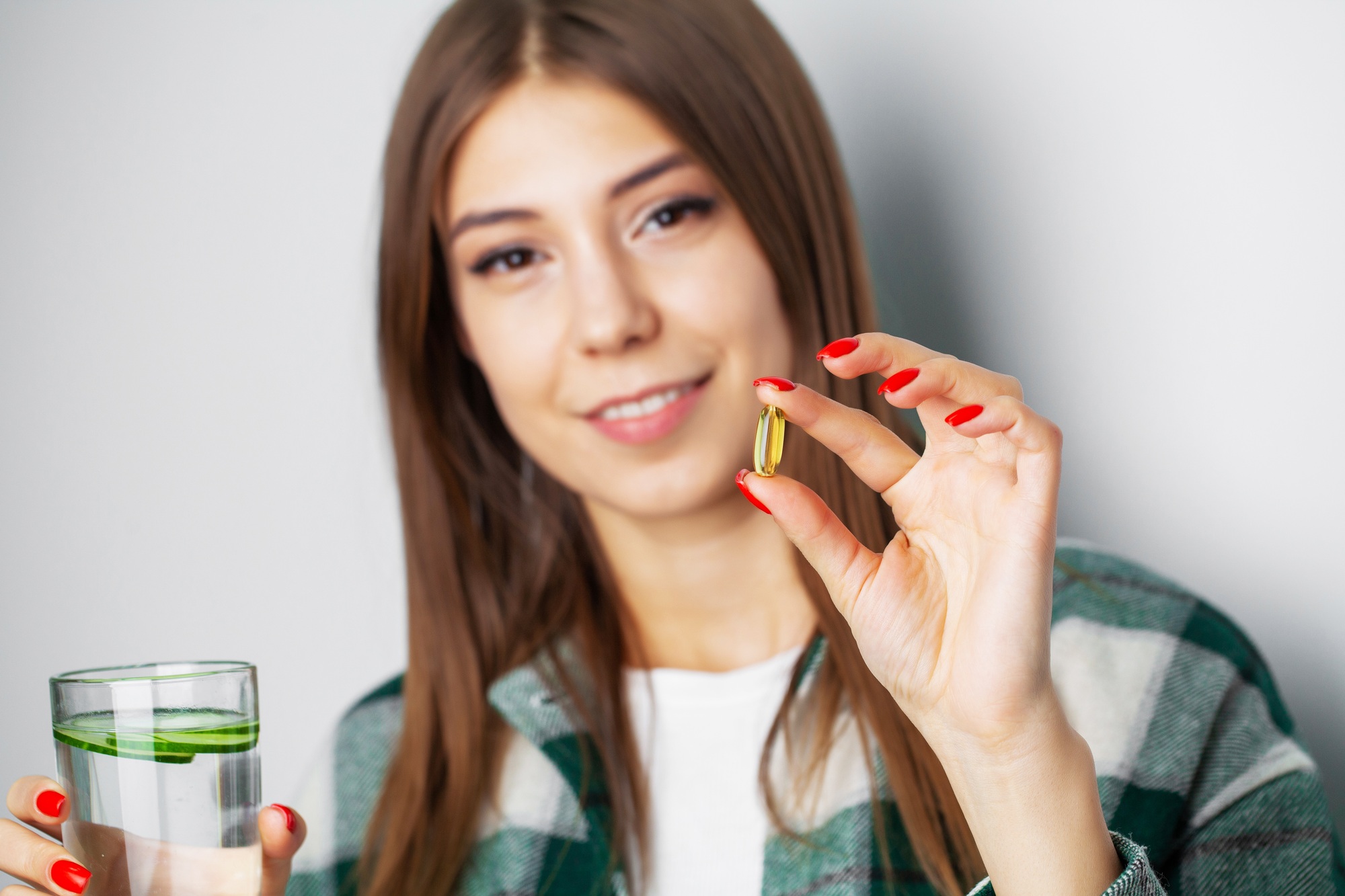 Beautiful girl takes a pill for weight loss