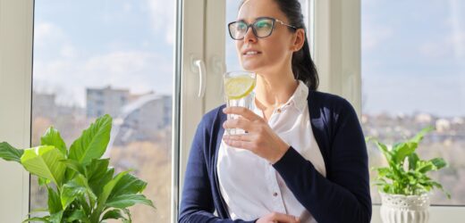 Business woman with glass of water with lemon