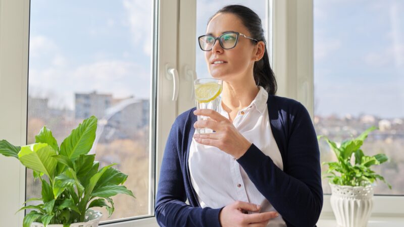 Business woman with glass of water with lemon