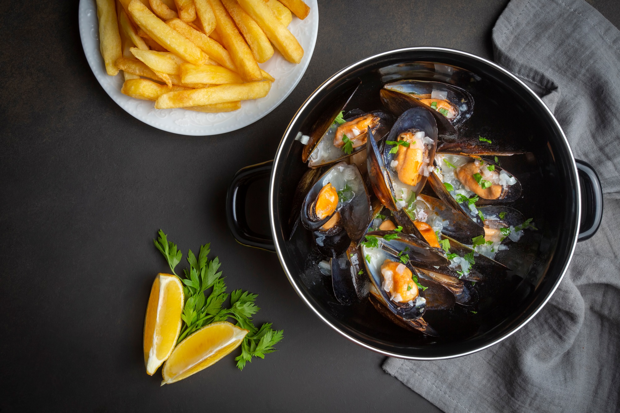 Delicious seafood mussels with parsley sauce and lemon. Delicious steamed mussels.