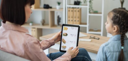 Ladies checking discounts on food delivery online website