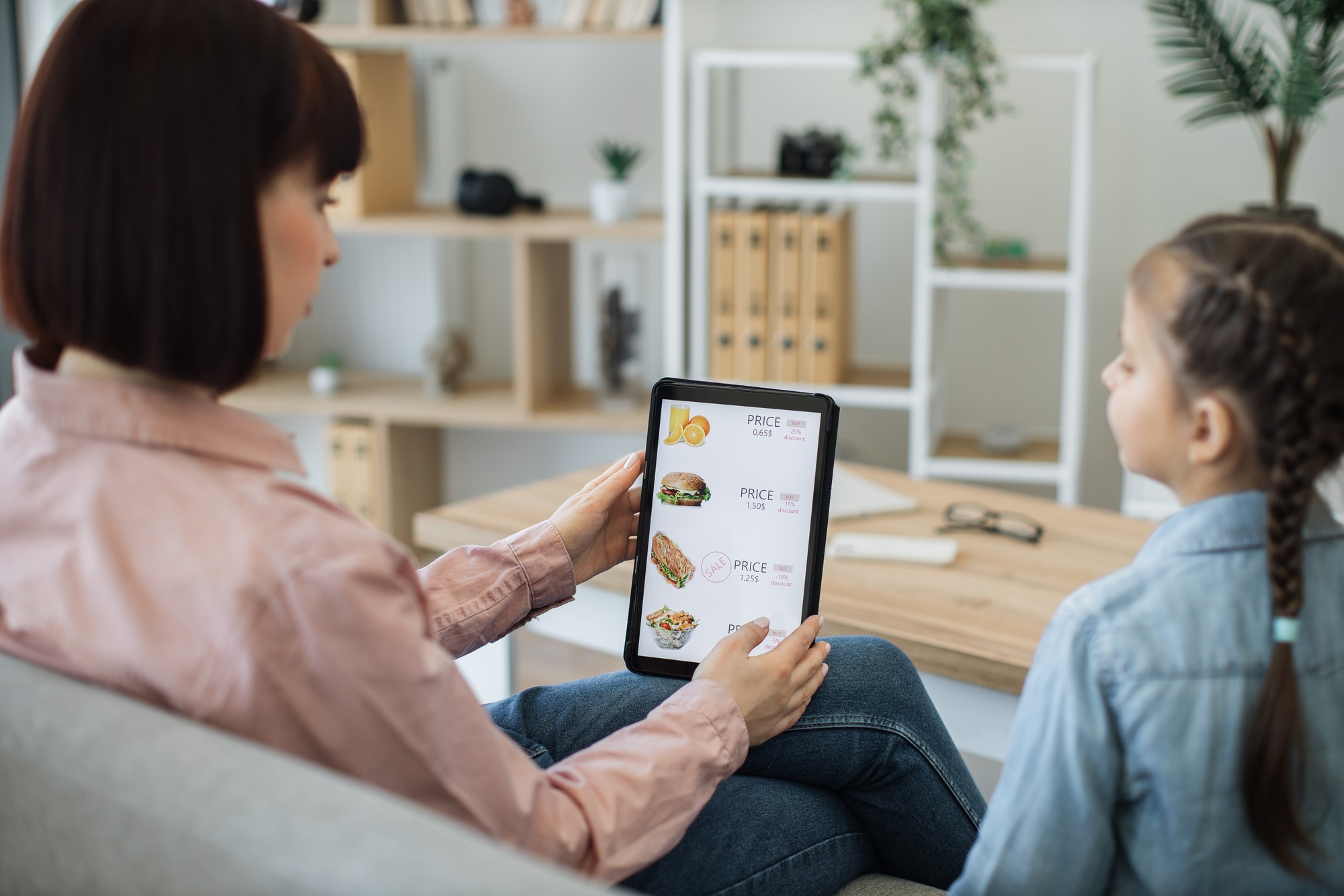 Ladies checking discounts on food delivery online website
