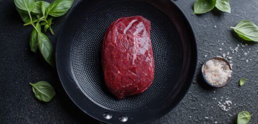 Raw meat with spices and herbs on table