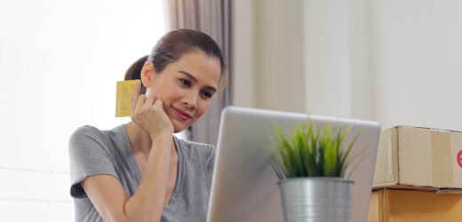 Asian beautiful girl buying online from website using credit card for payment.