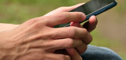 Cell phone, smartphone in the hands of a man.