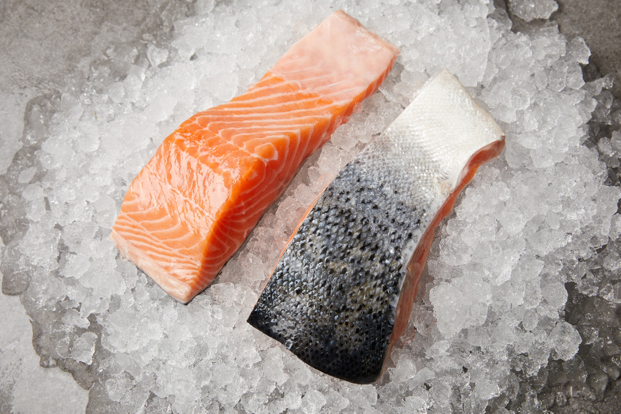 close-up shot of sliced salmon fillet on crushed ice
