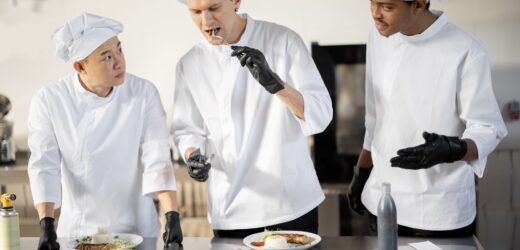 Cooks with different nationalties tasting cooked meals for restaurant menu