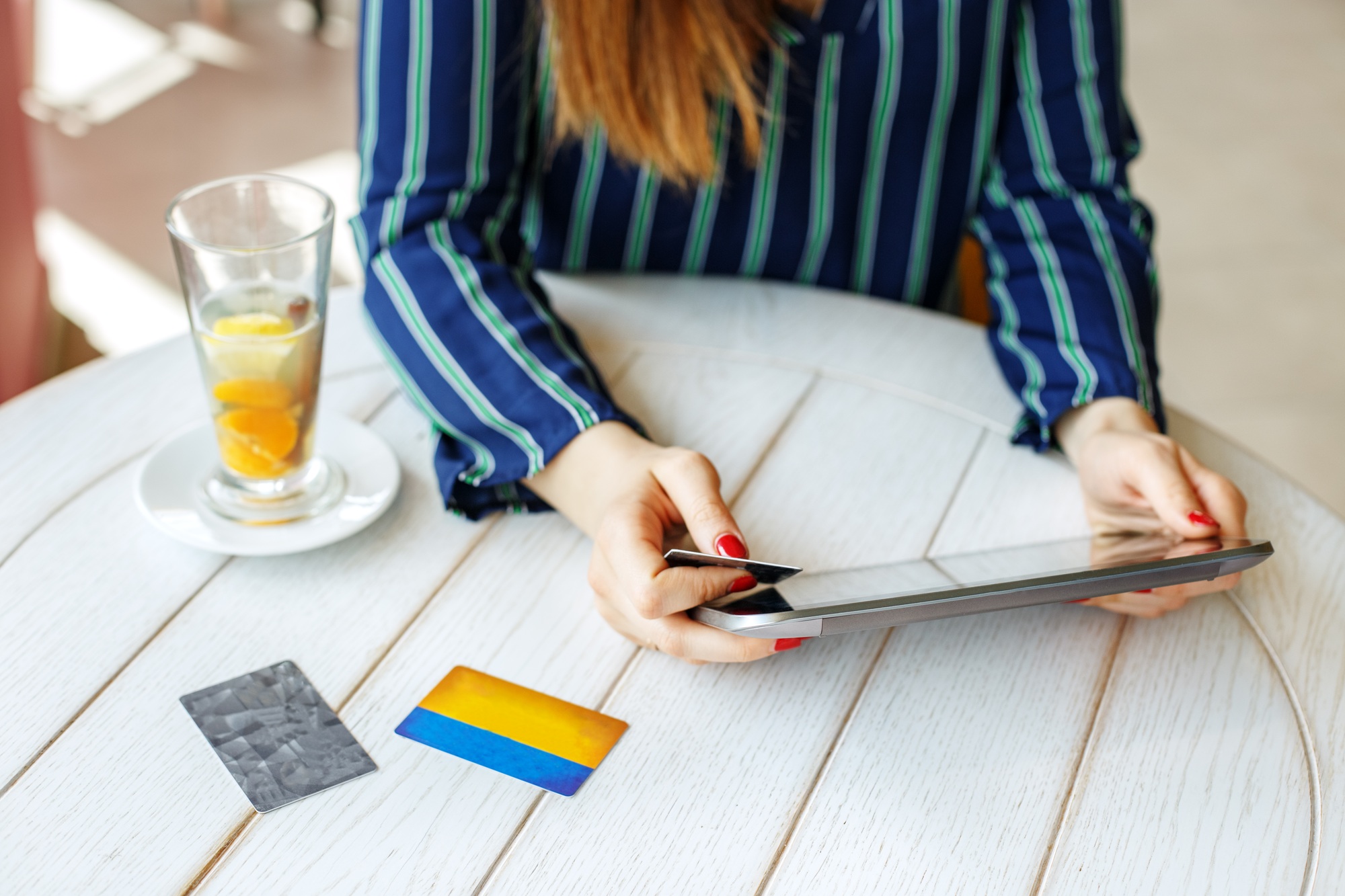 Girl who buys online with a tablet and a credit card. The concep