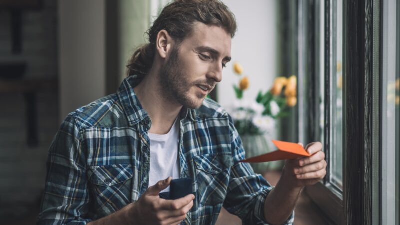 Handsome man reading a letter by his bride