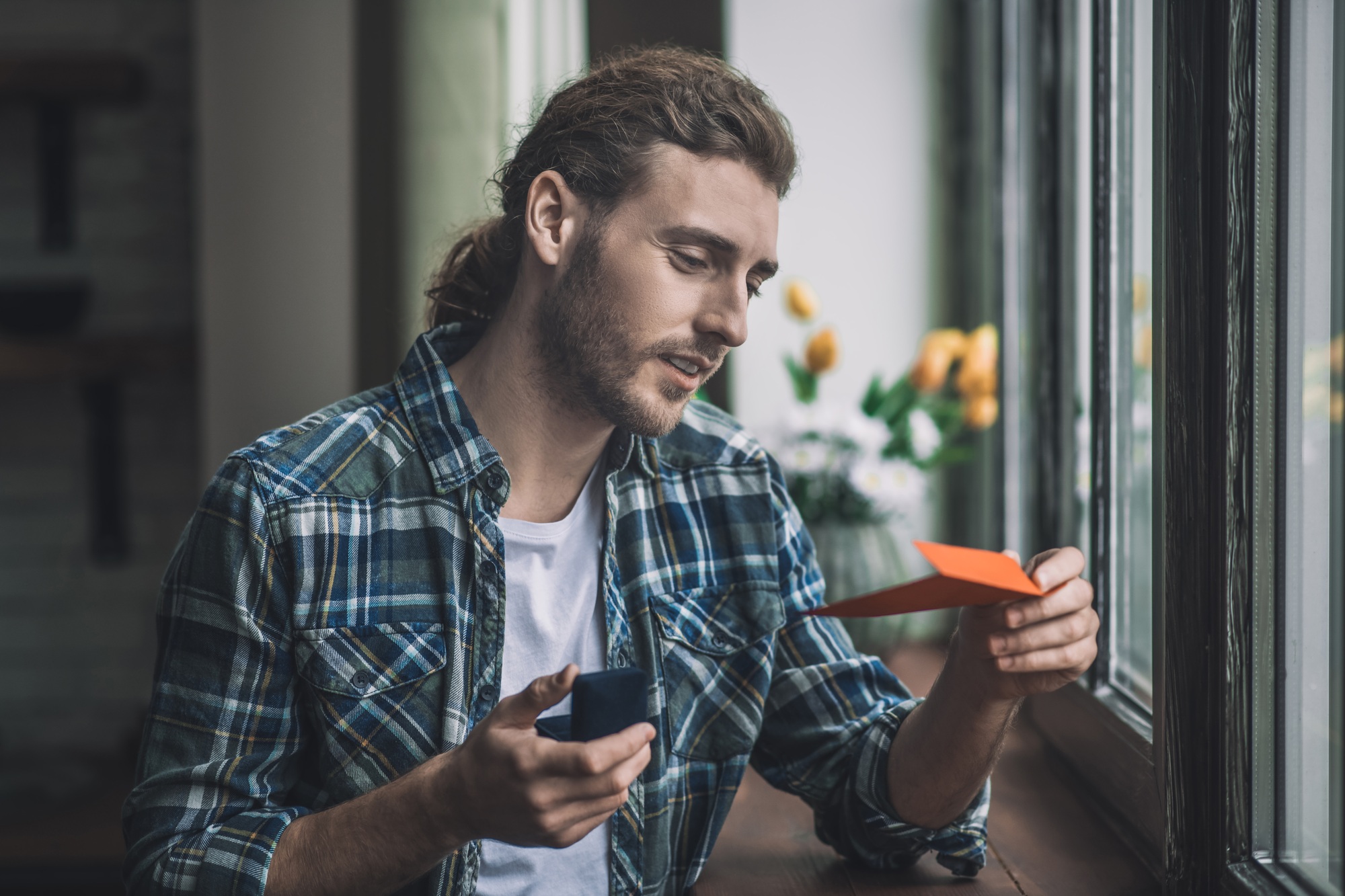 Handsome man reading a letter by his bride