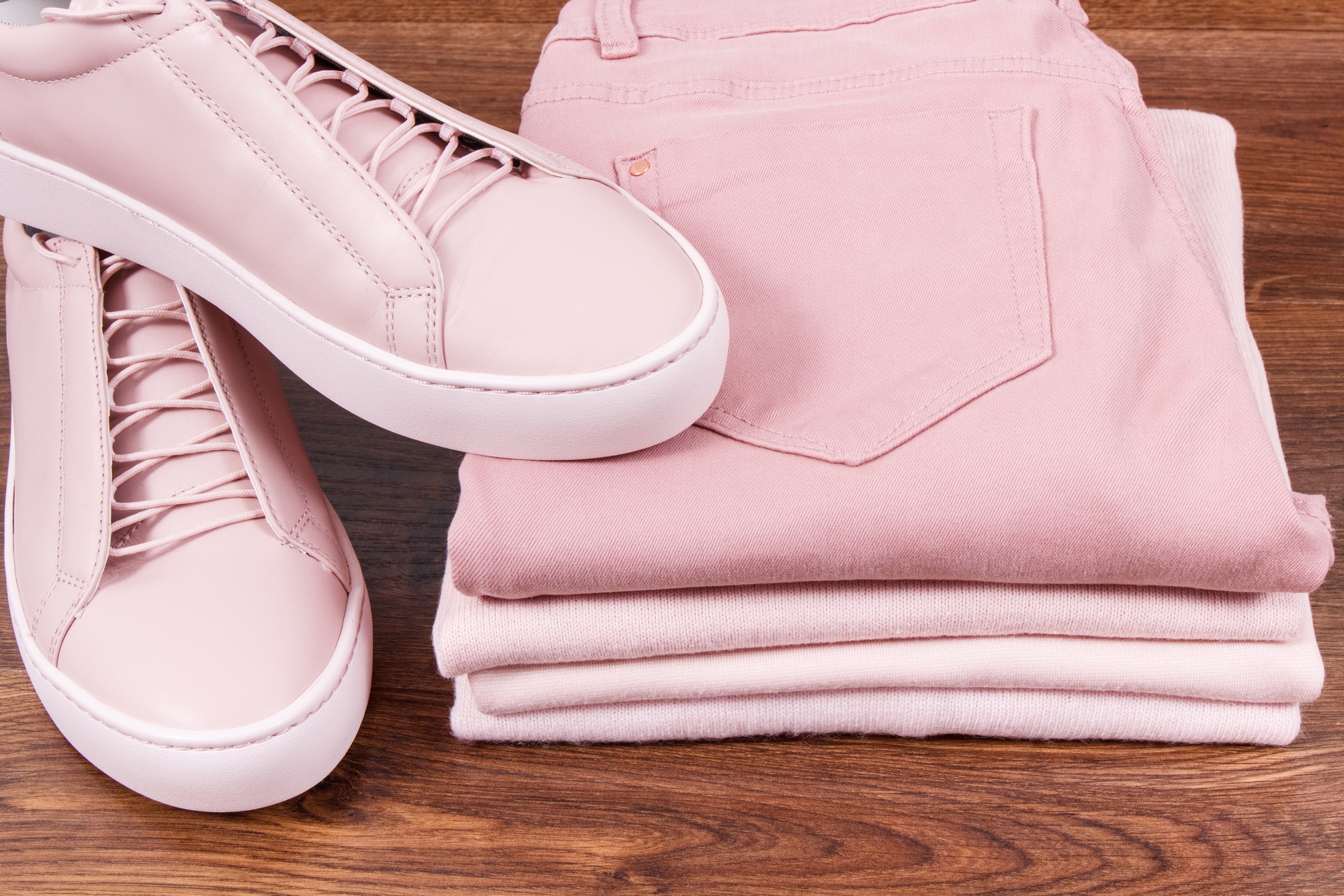Leather shoes, pants and clothing for woman on rustic board