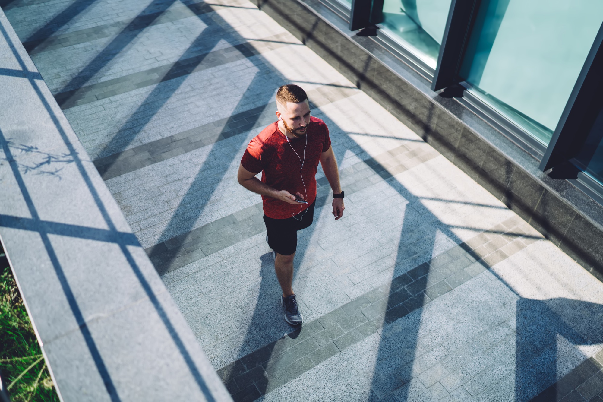 Man in earphones walking on street