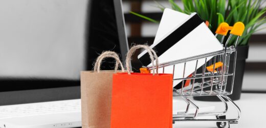 Online shopping concept. Shopping cart, laptop on the desk