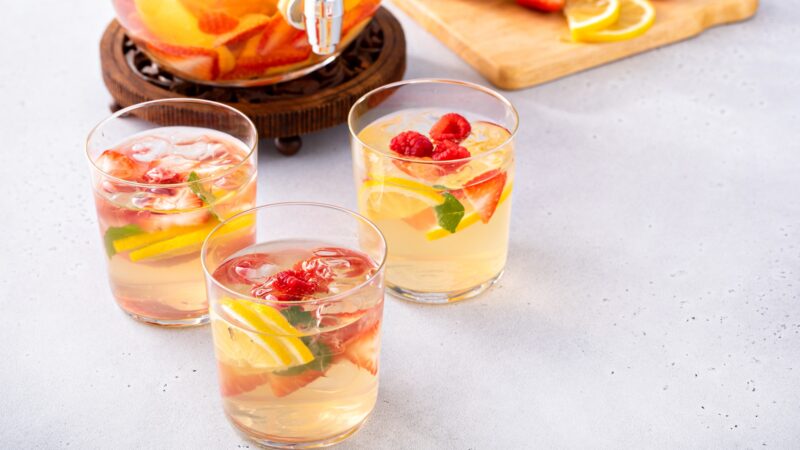 Summer sangria punch in a pitcher and glasses