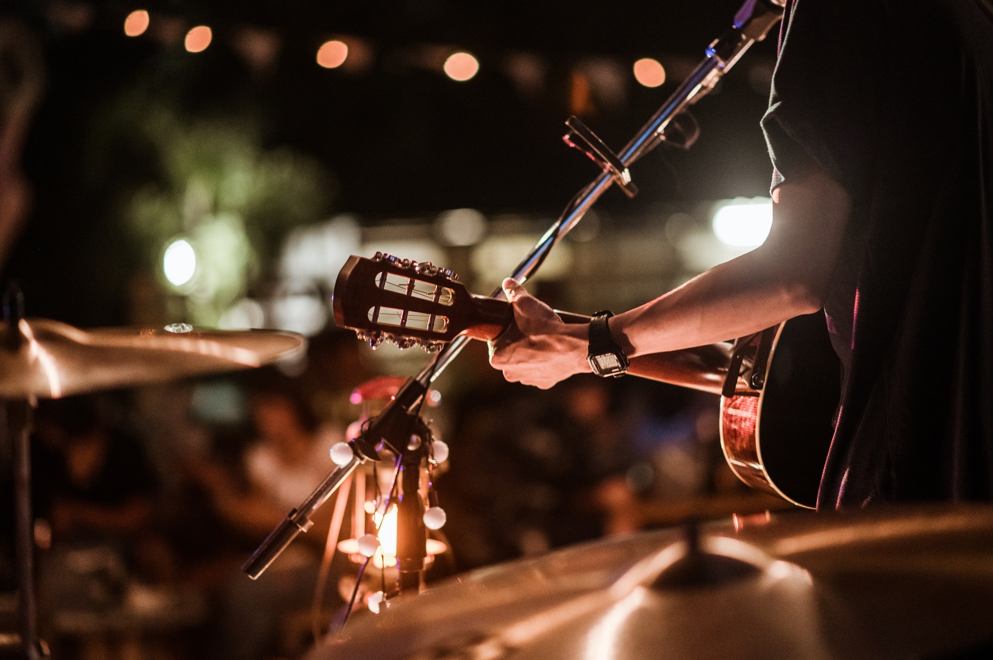 The musicians were playing rock music on stage, there was an audience full