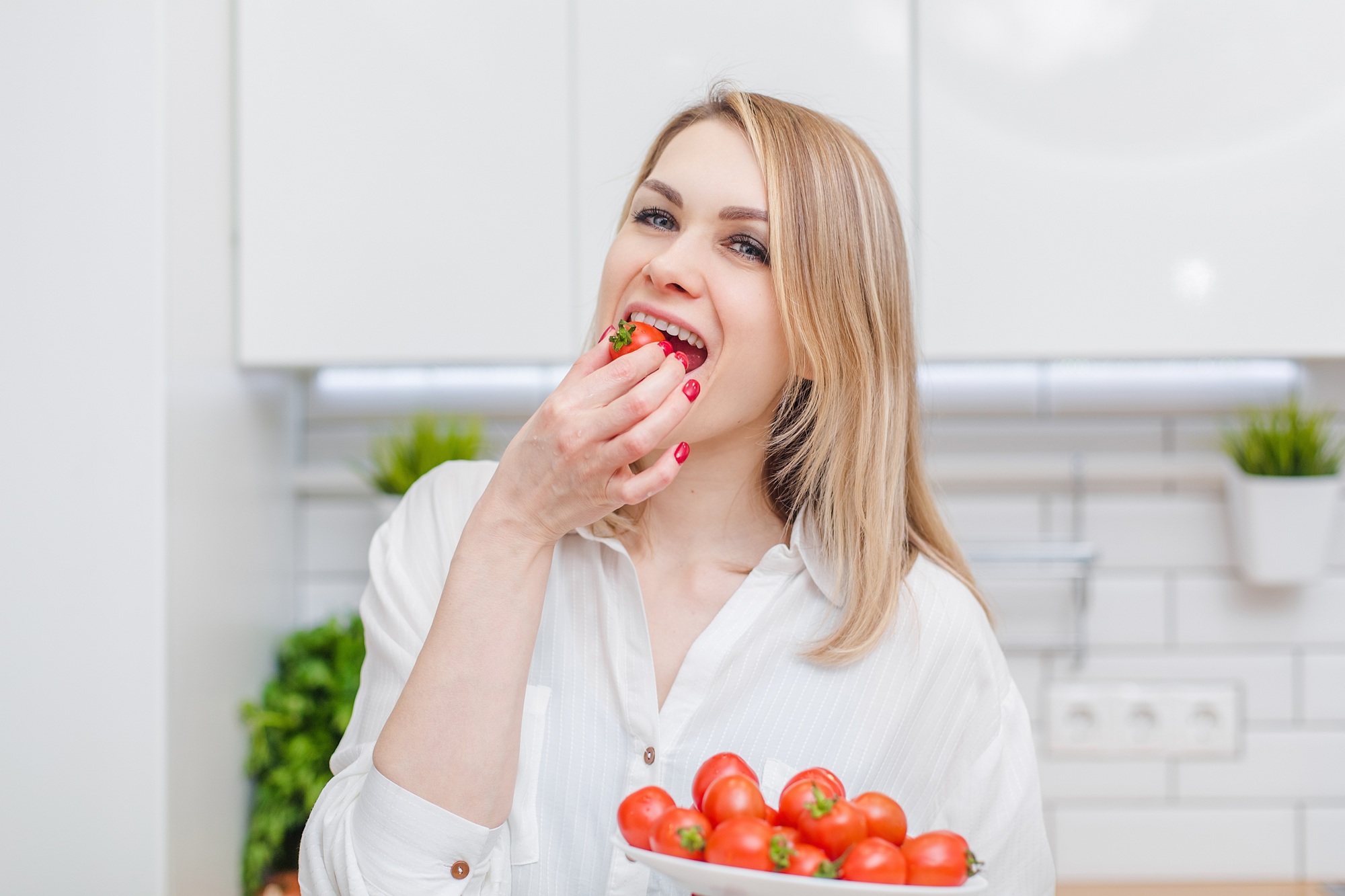 Woman eating tomato