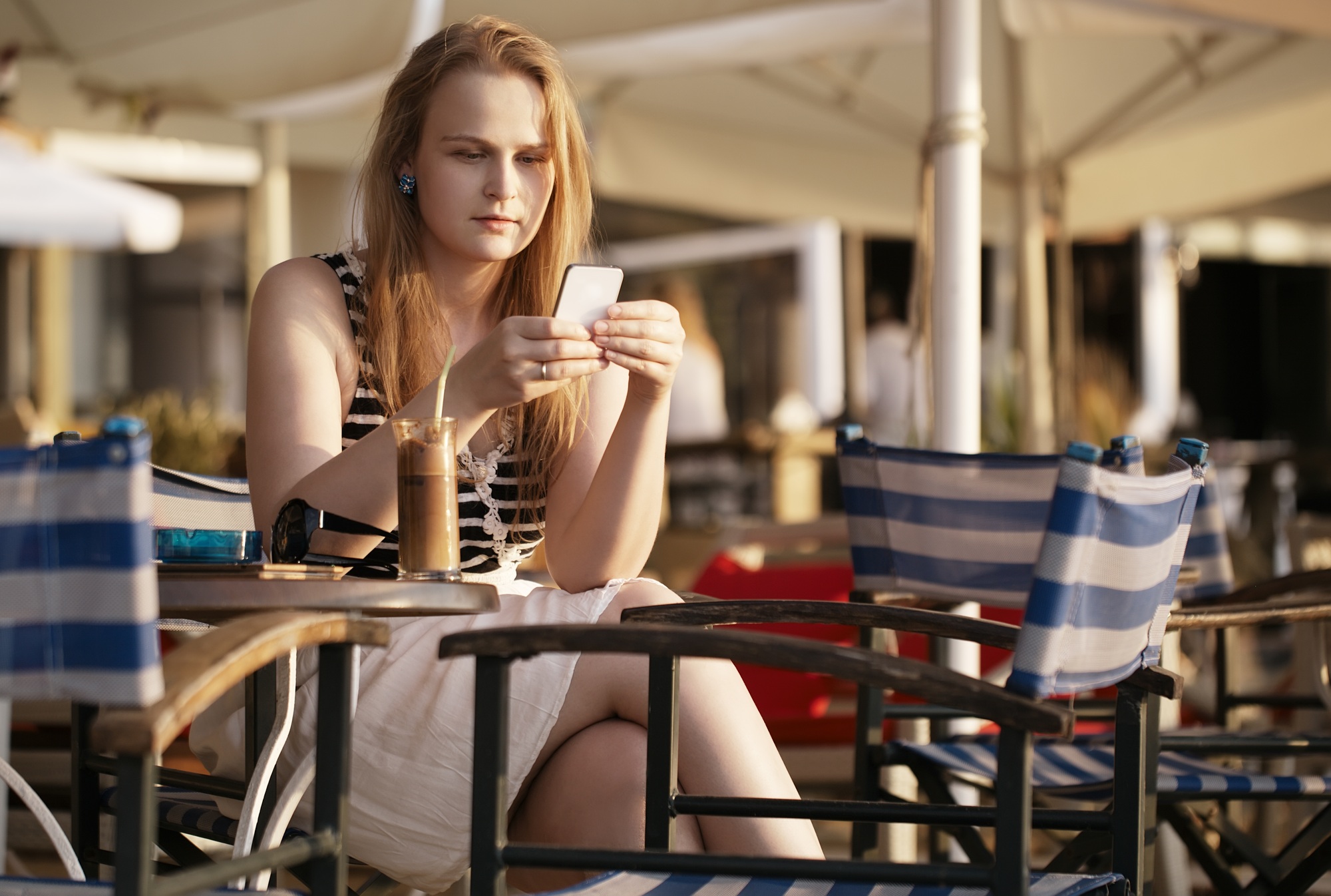 Woman sending an sms on her mobile