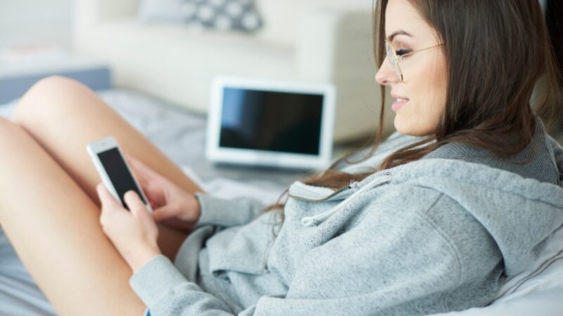 Young woman text messaging at the morning